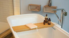 Badewannen-Tablett mit Buch und Pflegeprodukten